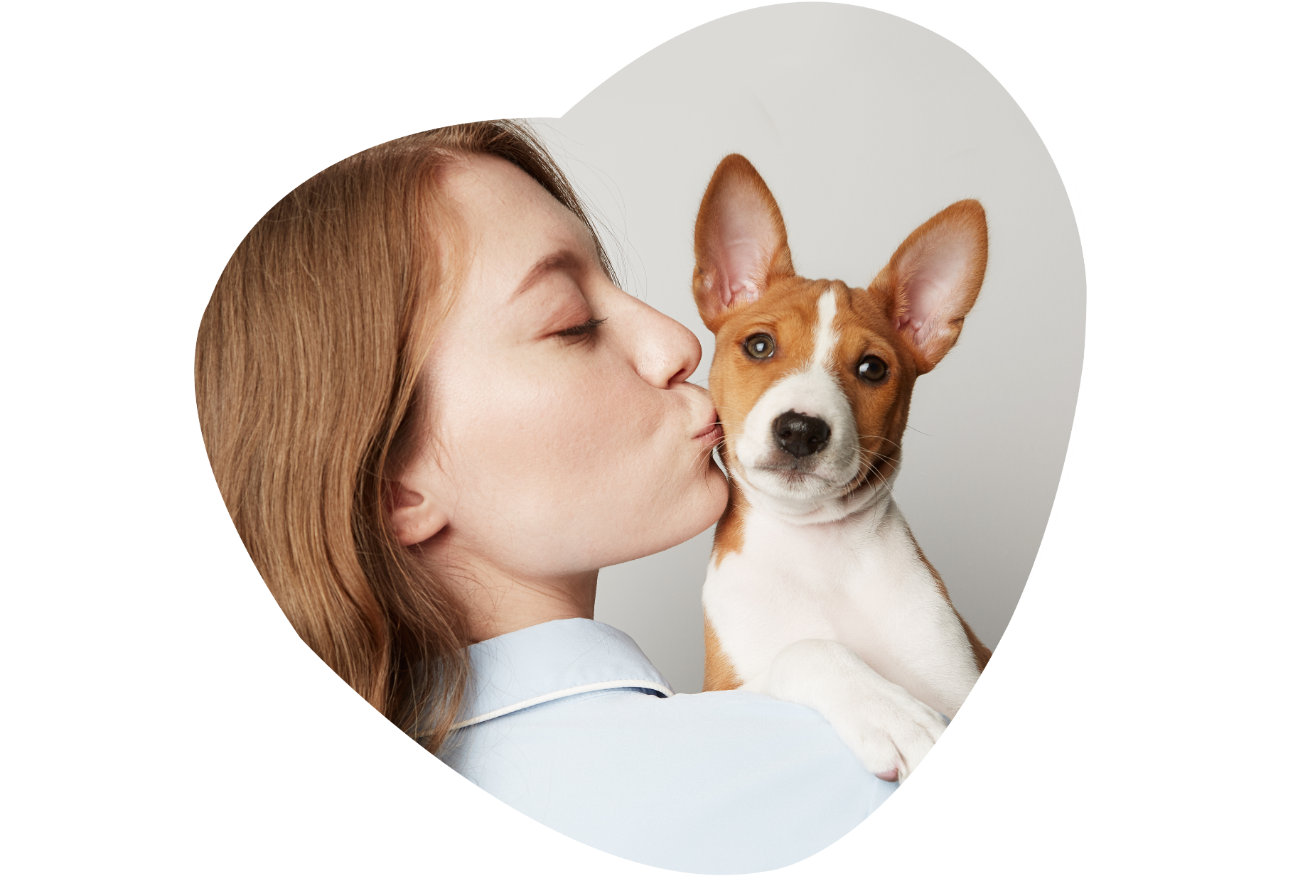 Woman kissing her dog
